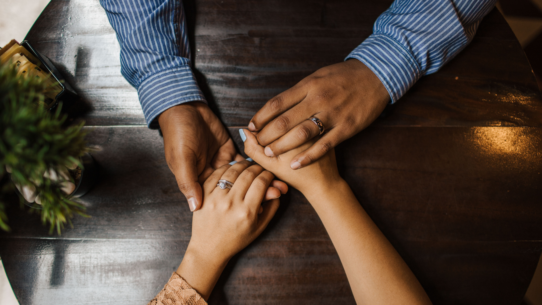 husband and wife hold hands