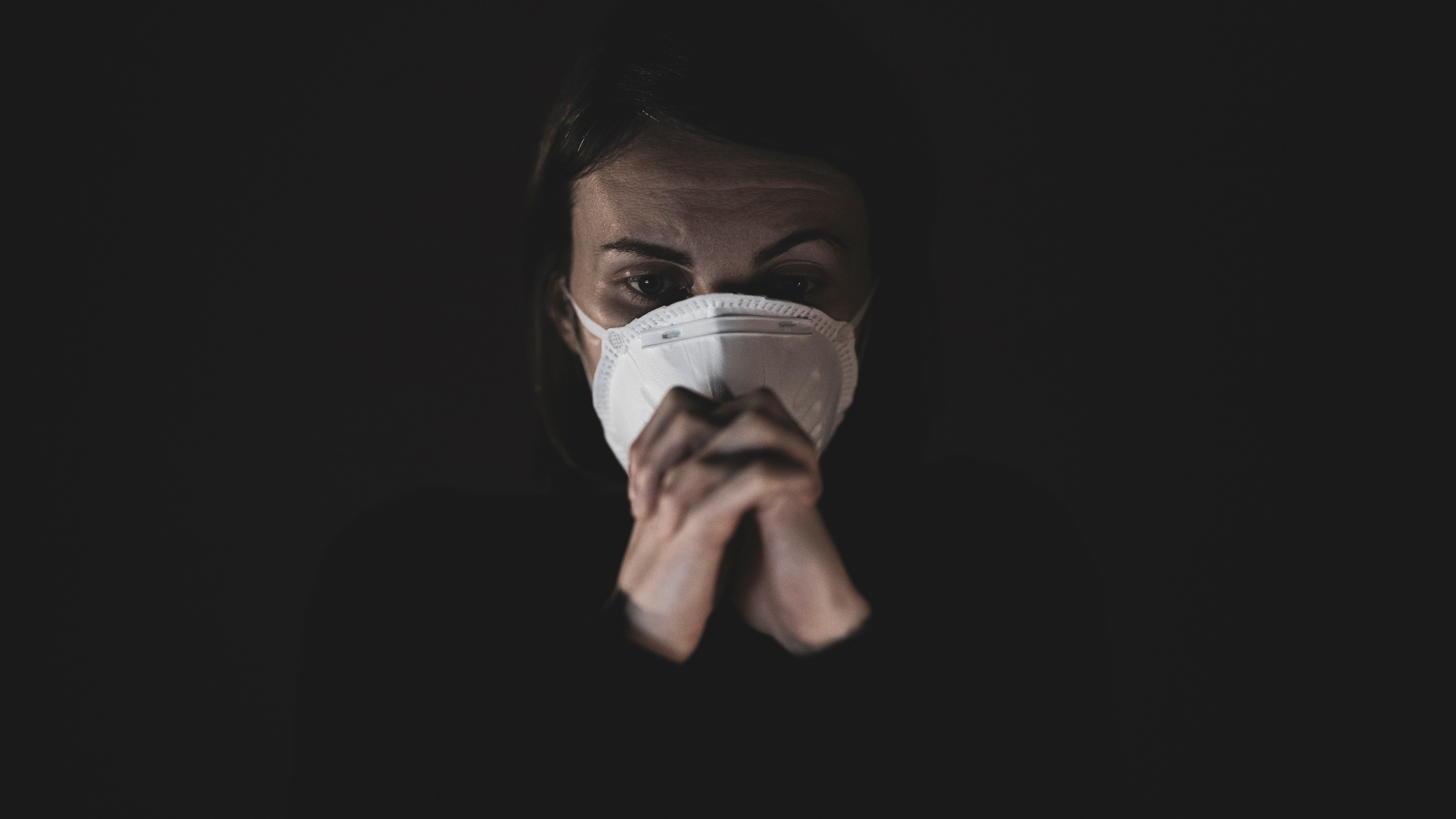 praying woman with mask