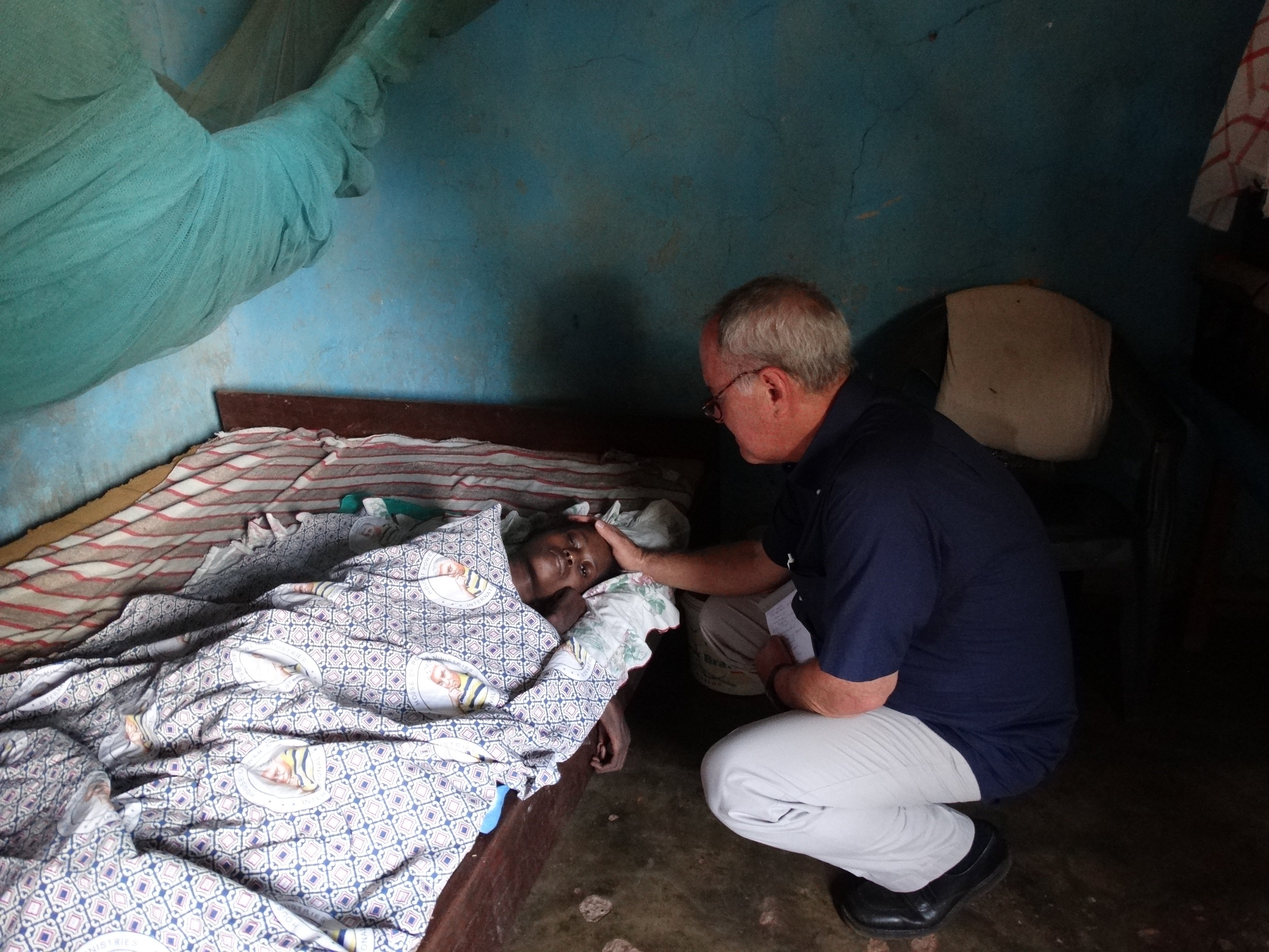 Carl praying for the girl in Ghana