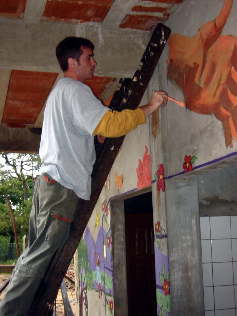 AJ Painting a mural on a mission trip